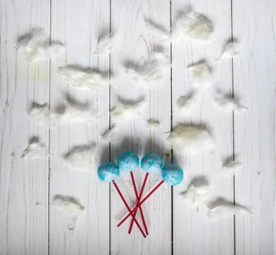 Blue cakepops among the candy-floss clouds Stock Photos