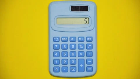Blue calculator on yellow background. Stop motion animation Stock Footage 286148125
