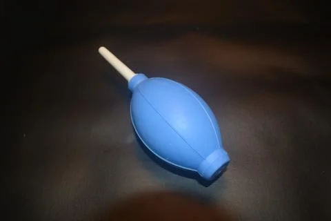 Blue camera lens blower, camera cleaning tool, isolated on black background Stock Photos