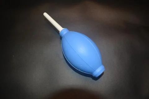Blue camera lens blower, camera cleaning tool, isolated on black background Stock Photos