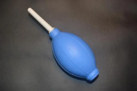 Blue camera lens blower, camera cleaning tool, isolated on black background Stock Photos