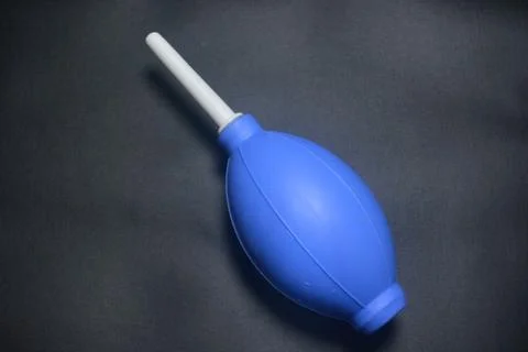 Blue camera lens blower, camera cleaning tool, isolated on black background Stock Photos