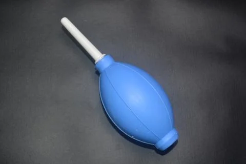 Blue camera lens blower, camera cleaning tool, isolated on black background Stock Photos