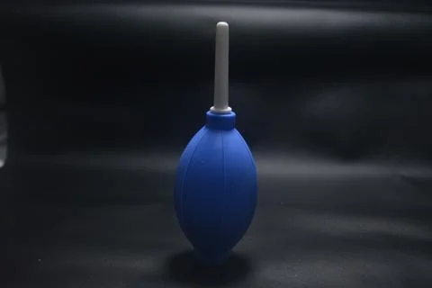 Blue camera lens blower, camera cleaning tool, isolated on black background Stock Photos