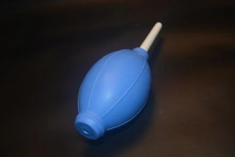 Blue camera lens blower, camera cleaning tool, isolated on black background Stock Photos