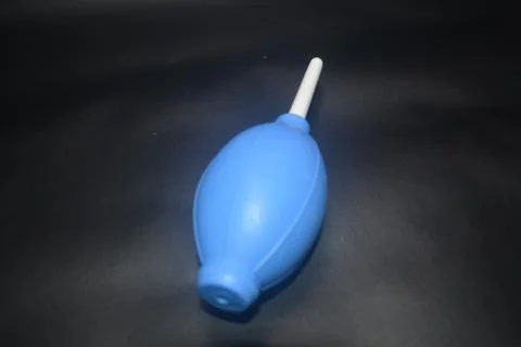 Blue camera lens blower, camera cleaning tool, isolated on black background Stock Photos