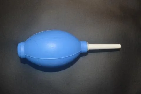 Blue camera lens blower, camera cleaning tool, isolated on black background Stock Photos