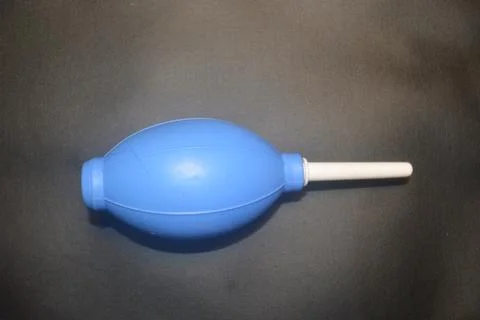 Blue camera lens blower, camera cleaning tool, isolated on black background Stock Photos