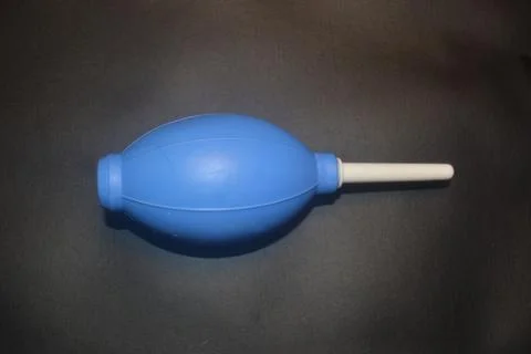 Blue camera lens blower, camera cleaning tool, isolated on black background Stock Photos