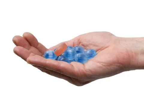 Blue candies in a hand Stock Photos