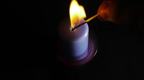 A blue candle on a black background Stockbeeldmateriaal 53767524