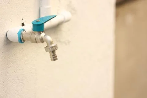 Blue cap pipe on the wall Stock Photos