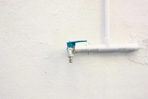 Blue cap pipe on the wall Stock Photos