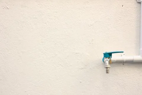 Blue cap pipe on the wall Stock Photos