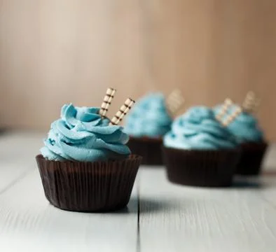 Blue capcake on a light background Stock Photos
