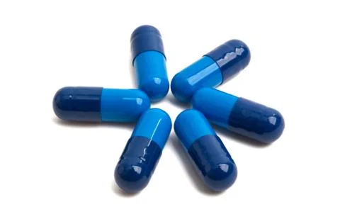 Blue capsules isolated Stock Photos
