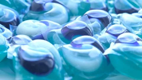Blue capsules for washing clothes in an automatic machine. The concept of Vídeos de archivo 253112544