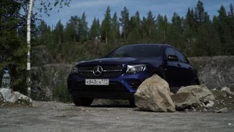 Blue car against the backdrop of mountains and forests. Stock Footage 150108598