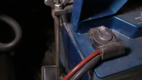 Blue Car Battery Terminal with Connected Cables Inside Engine Bay Stock Footage 335643629