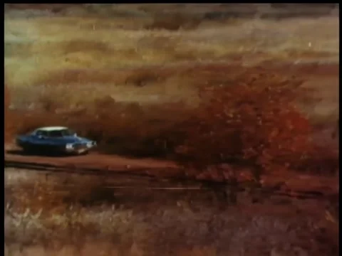 Blue car driving down dirt road in countryside Video stock 260247736
