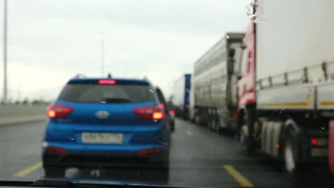 Blue car in traffic jam on a rainy day, view through windshield with raindrops Stock Footage 337154257
