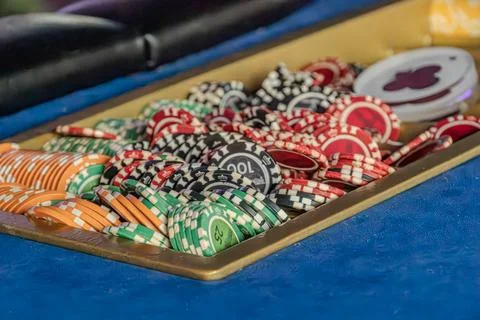 Blue card table with a spread deck of playing cards, featuring various denomi Stock Photos