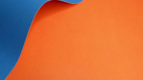 Blue cardboard on an orange background is moving. The texture of the cardboard. Stock Footage 157393210