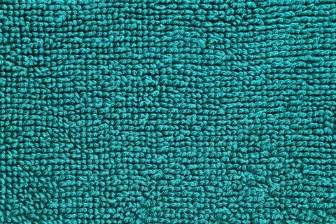 A blue carpet with a pattern of small squares Stock Photos