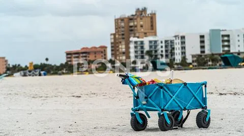 Blue cart on sandy beach ominous clouds Stock Image #153503836