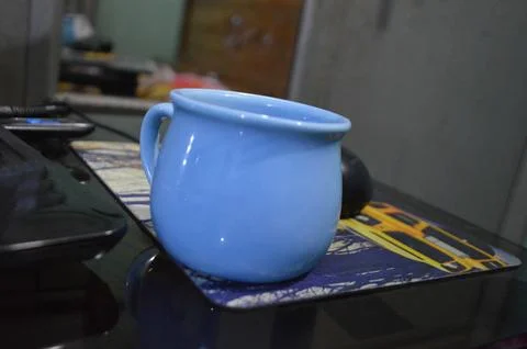 Blue ceramic cup on a table in the kitchen. Close up. Stock Photos