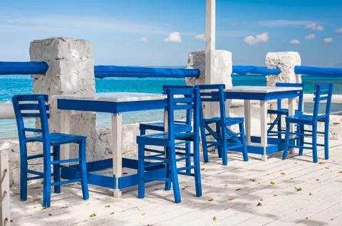 Blue chairs and white tables. Stock Photos