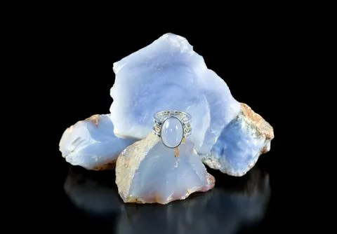 Blue chalcedony ring and rough Stock Photos