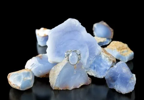 Blue chalcedony ring and rough Stock Photos