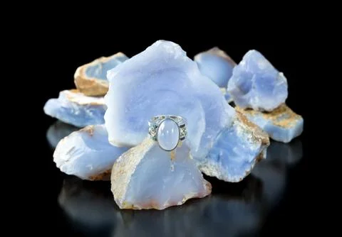 Blue chalcedony ring and rough Stock Photos
