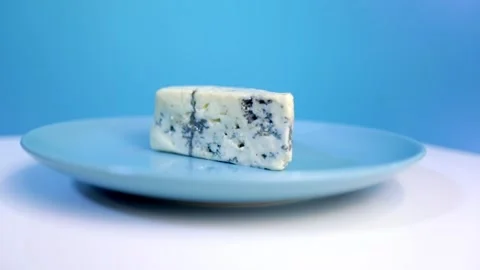 Blue cheese rotates on a plate Stock Footage 160397829