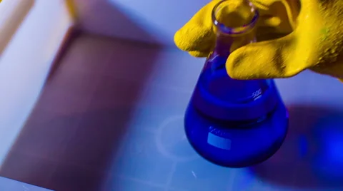 Blue chemical solution holding hold flask Stock Footage
