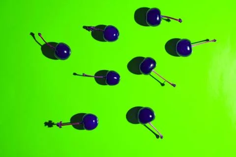 Blue cherry on light green background with shadows effect. Concept photo.Top  Stock Photos