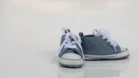 Blue children's sneakers with laces Stock Photos