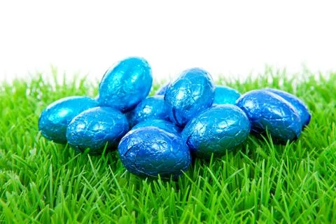 Blue chocolate easter eggs on grass Stock Photos