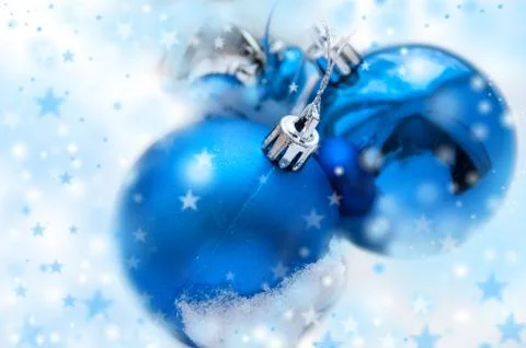 Blue Christmas balls in the snow on a white background Stock Photos