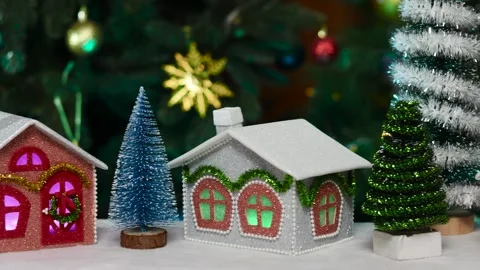 A blue Christmas tree between a gray and burgundy house Stock Footage 264680519