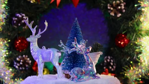A blue Christmas tree surrounded by Santa Claus on a sleigh and reindeer Stock Footage 283526406
