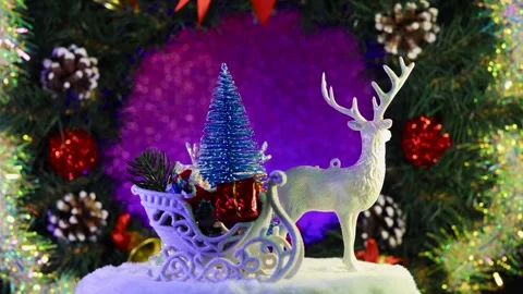 A blue Christmas tree surrounded by Santa Claus on a sleigh and reindeer Video stock 283526409