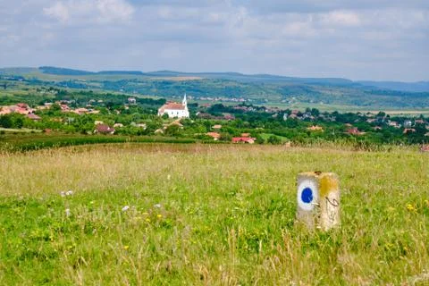 Blue circle with white background, a trail marking sign on a small concrete pole Stock Photos
