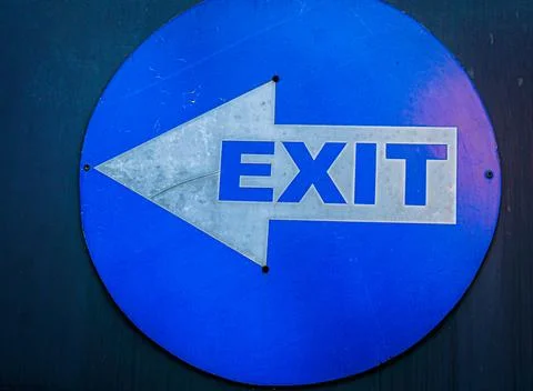 Blue Circular Exit Sign with White Directional Arrow Stock Photos