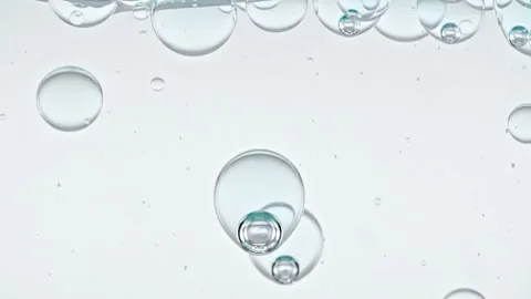 Blue Clear Bubbles Form and Float to Another Ones on Transparent Surface on Blue Stock Footage 272590099