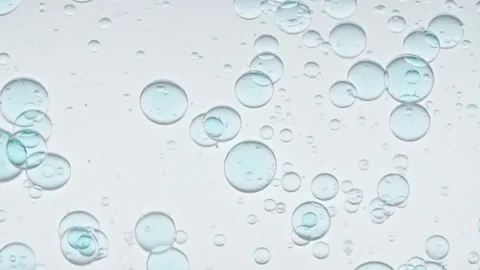 Blue Clear Bubbles Form and Float to Another Ones on Transparent Surface on Blue Stock Footage 274636565
