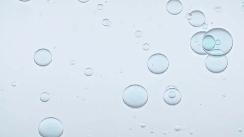 Blue Clear Bubbles Form and Float to Another Ones on Transparent Surface on Blue Stock Footage 276992189