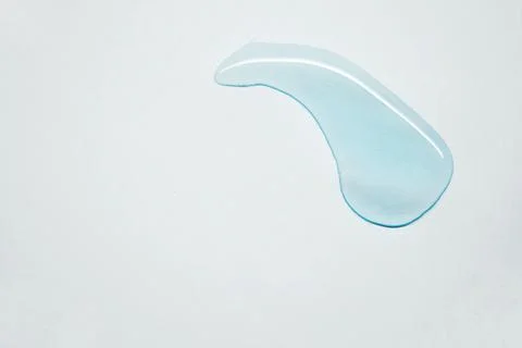 Blue clear drop on a white background Stock Photos