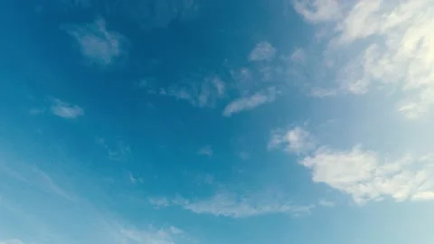 Blue clear sky with air clouds on a very sunny day Stock Footage 169590614